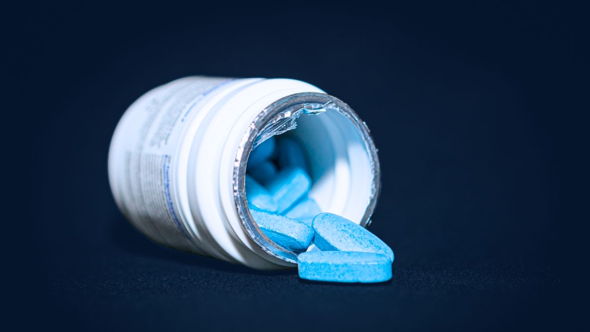 Hims & Hers app on phone with cracked data shield and hacker silhouette