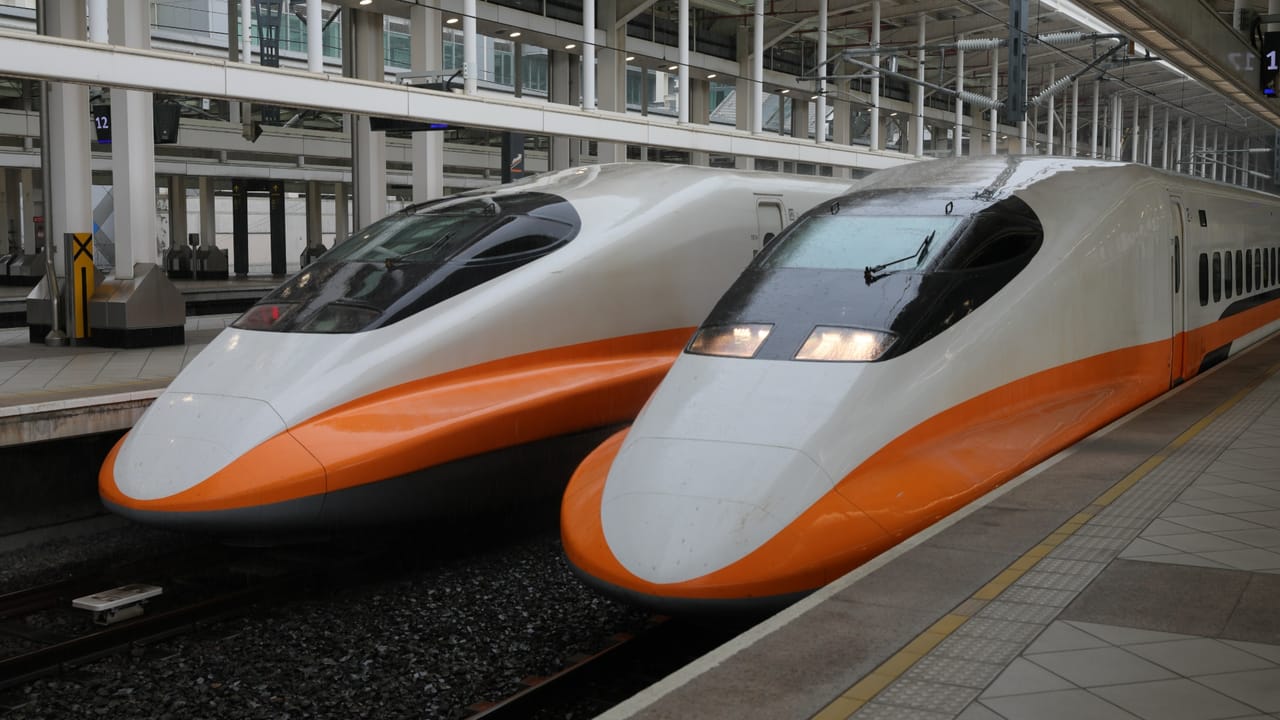 A high-speed bullet train moving rapidly on tracks, symbolizing transportation infrastructure.