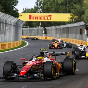 Formula 1 car speeding on a track with digital overlays indicating cyber threats.