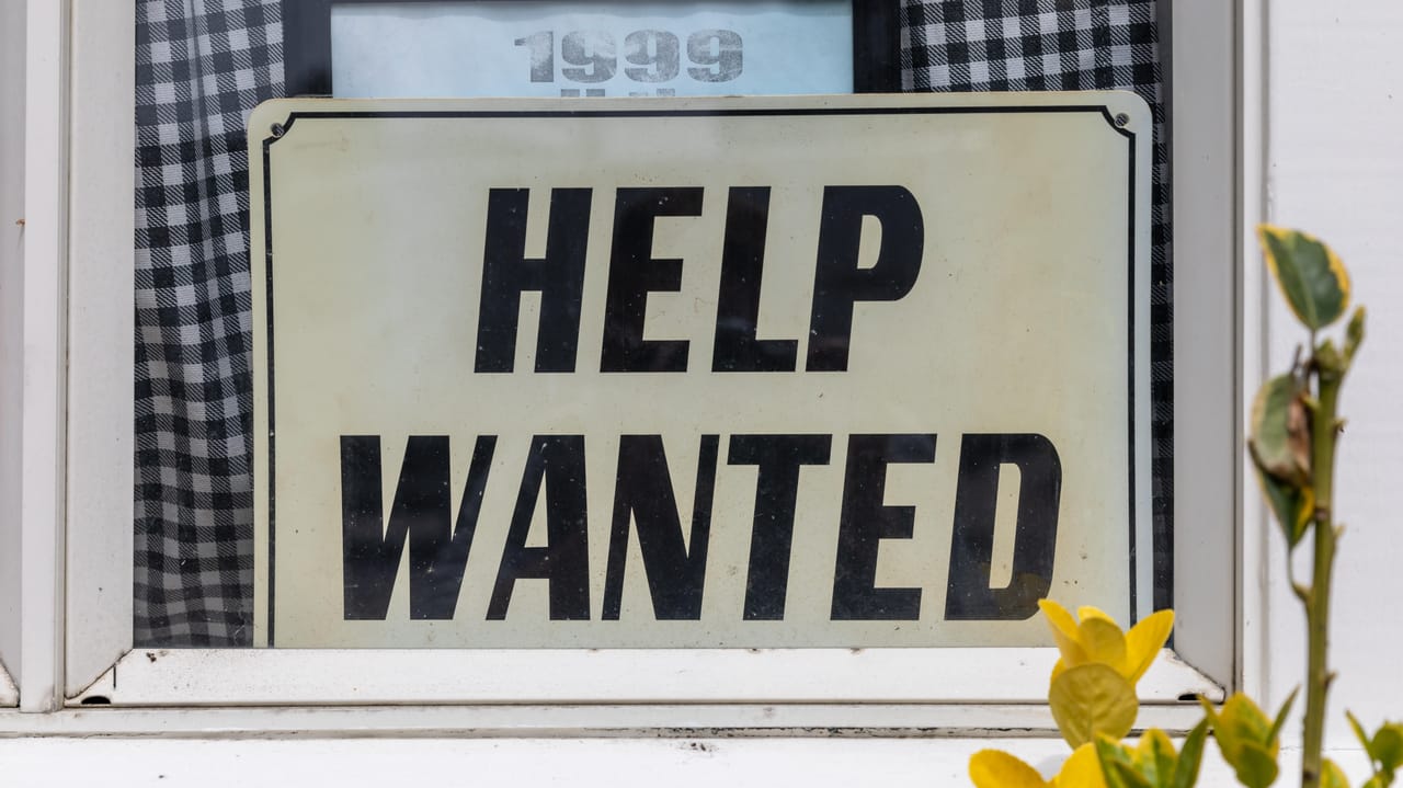 Vibrant Latin American coders collaborating on cybersecurity defenses in a bustling tech hub