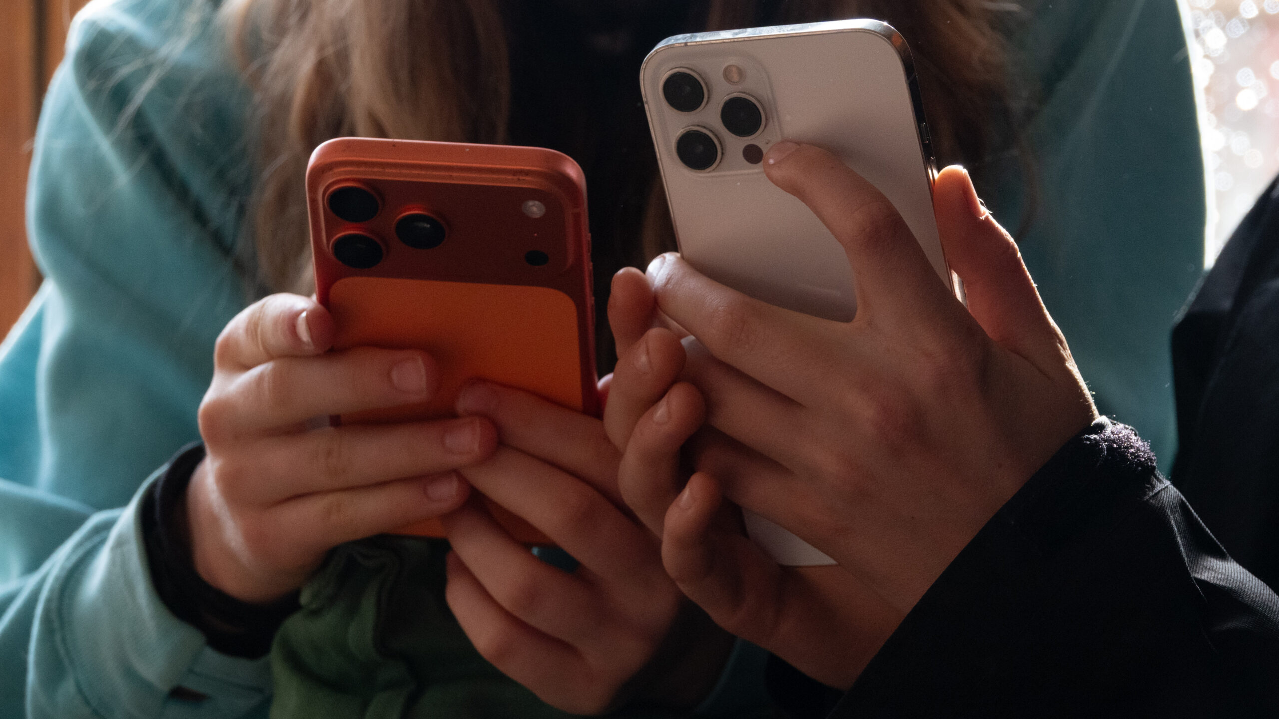 Shadowy digital sword piercing an iPhone screen amid glowing website code